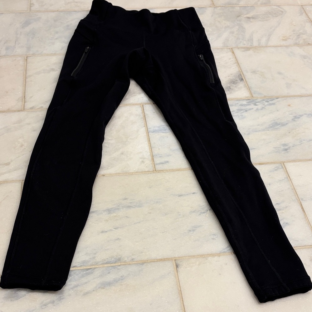 Athleta fleece lined Black Leggings with Zipper Pockets. Like new condition.